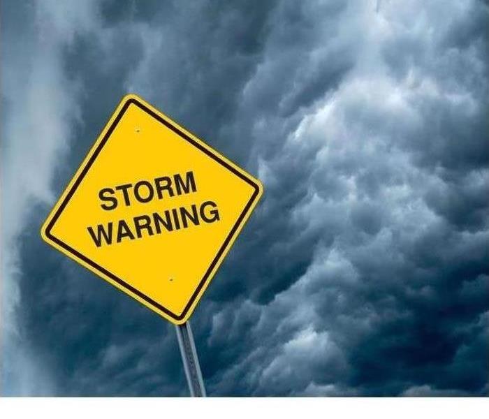 Storm Warning Sign in front of Cloudy Weather